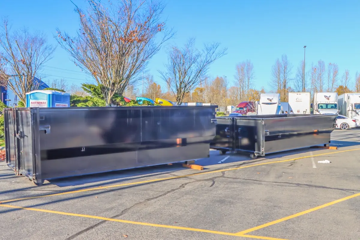 Professional dumpster rental service with roll-off container on residential driveway in Lehigh